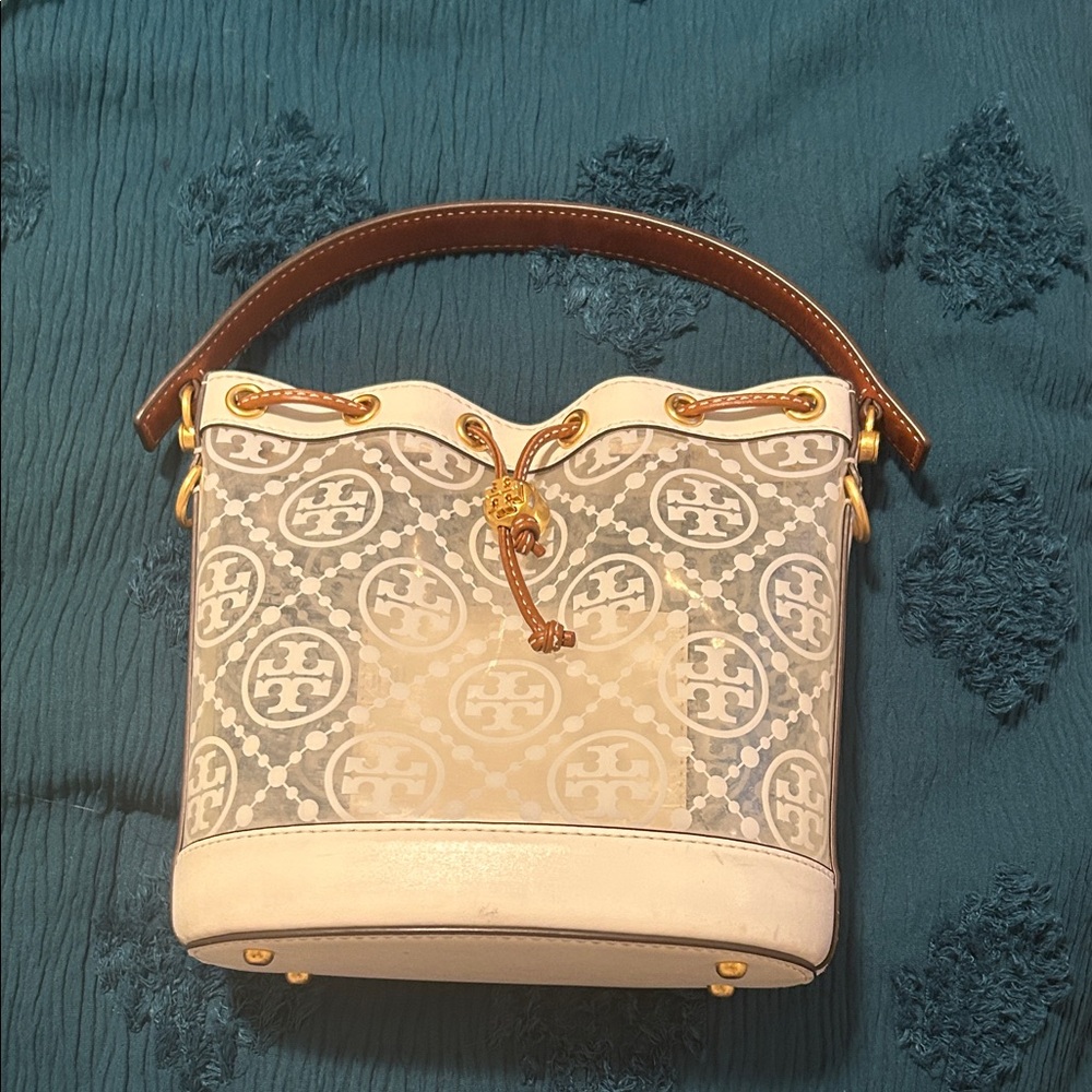 Tory Burch White Logo Drawstring Bucket Shoulder Bag with Brown Handle.